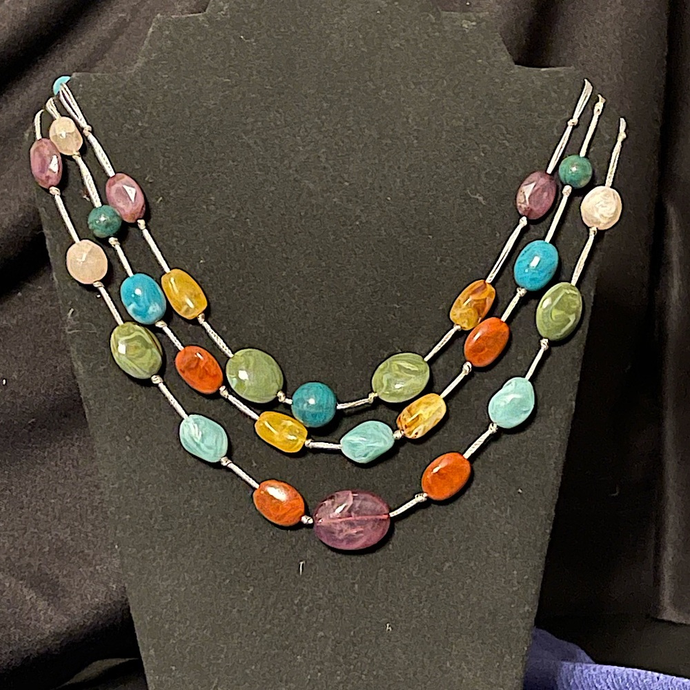 Colorful NECKLACE Three strands of faux polished stones on silver string.